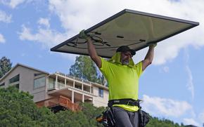 A man installs a solar panel at a home Wednesday, Aug. 10, 2022, in Salt Lake City. Congress is poised to pass a transformative climate change bill on Friday, Aug. 12.