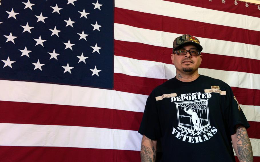 Ivan Ocon, who grew up in Las Cruces but was deported to Mexico for breaking the law, stands in front of a U.S. flag at his home in Juárez in 2019.
