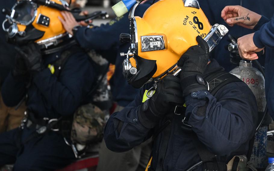 U.S. Navy sailors make pre-dive checks onboard the salvage ship USNS Salvor during the ongoing CV-22B Osprey recovery efforts off Yakushima, Japan, Dec. 27, 2023.