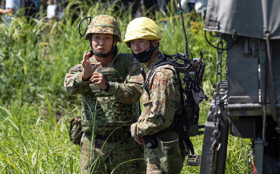 Japanese soldiers discuss anti-tank missile targets during Orient Shield drills with the U.S. Army at Oyanohara Training Area in Kumamoto, Japan, Sunday, Aug. 28, 2022.