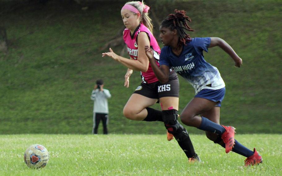 Guam High's NyKale Penn and Kadena's Sydney Pontious chase the ball during Tuesday's Division I girls soccer semifinal. Penn scored the only goal in the second overtime, beating her old Kadena teammates 1-0.