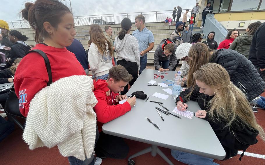 The community gathers write messages of support for Kaiserslautern High School sophomore football player Aiden Wall and his family.