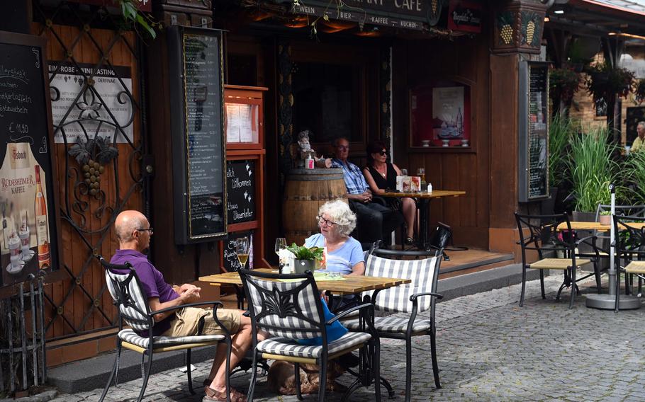 Visitors to Ruedesheim, Germany, enjoy drinks at a restaurant on Oberstrasse, in the city’s old town. Ruedesheim is a popular wine-producing town on the Rhine River, west of Wiesbaden.