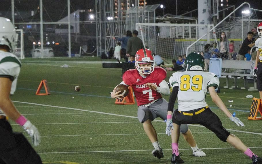 Nile C. kinnick's Zeke DeLaughter makes a running play while trying to outmaneuver Robert D. Edgren's defense.