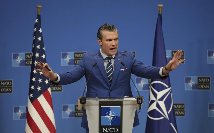 U.S. Secretary of Defense Pete Hegseth speaks with his hands up