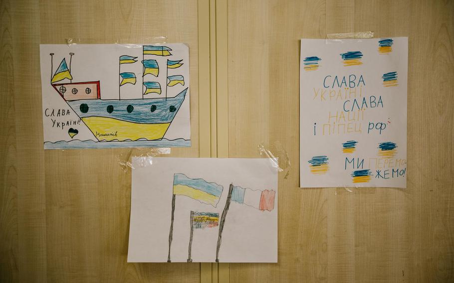 Drawings by Ukrainian children are on display by the ferry's information desk.