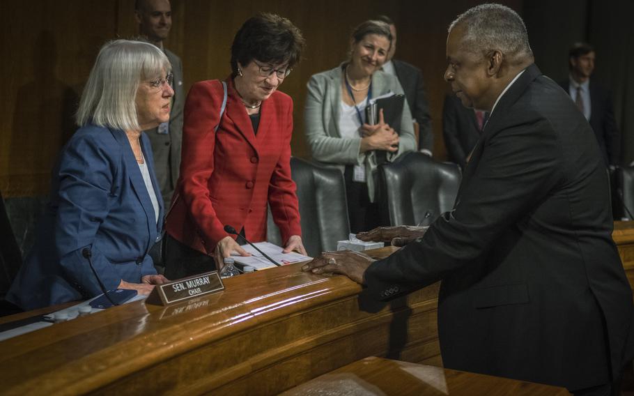 Defense Secretary Lloyd Austin speaks with Sens. Patty Murray, D-Wash., and Susan Collins, R-Maine, during a Senate Appropriations Committee hearing in May 2023.