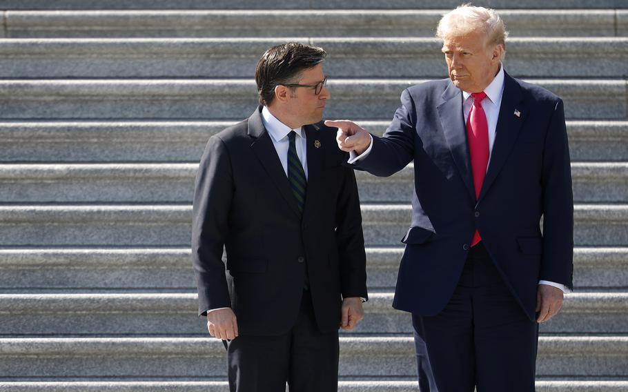 Mike Johnson and Donald Trump on the steps of the U.S. Capitol.