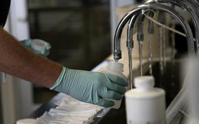 Geologist Ryan Bennett with the Illinois Environmental Protection Agency collects samples of treated Lake Michigan water in a laboratory at the water treatment plant in Wilmette, Ill., on July 3, 2021. An analysis of the samples detected a pair of toxic PFA chemicals at levels up to 600 times higher than the U.S. EPA's latest health advisory.