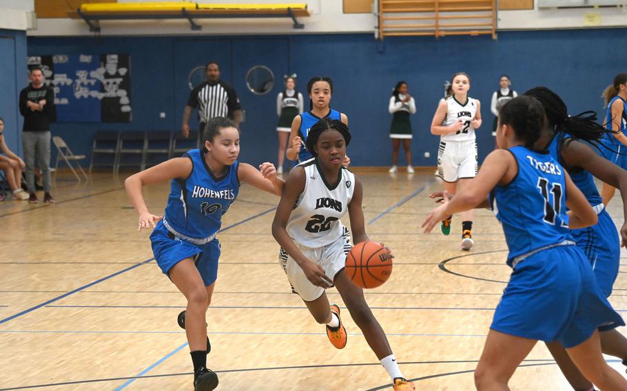 AFNORTH’s Makayla McNiel fights through Hohenfels defenders on a fast break during a game against the Tigers at Hohenfels High School on Jan. 13, 2024.