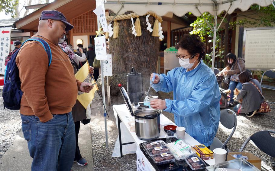 U.S. Army veteran Keikoa Villarin waits in line for amazake, a fermented rice drink, on Girls' Day at Zama Shrine, March 3, 2023. 