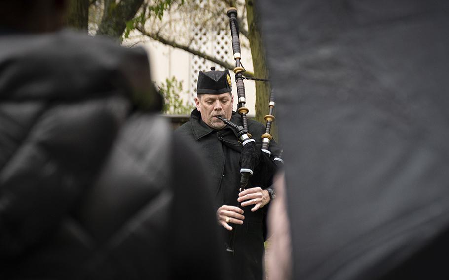 Shane Schiermeier plays the bagpipes during a memorial for Ronny Coleman in Kaiserslautern, Germany, Friday, April 28, 2023. Coleman worked at an AAFES Express shop on Kleber Kaserne and died last March. The Kleber community chipped in to buy him a gravestone, which was unveiled at Friday's ceremony. 
