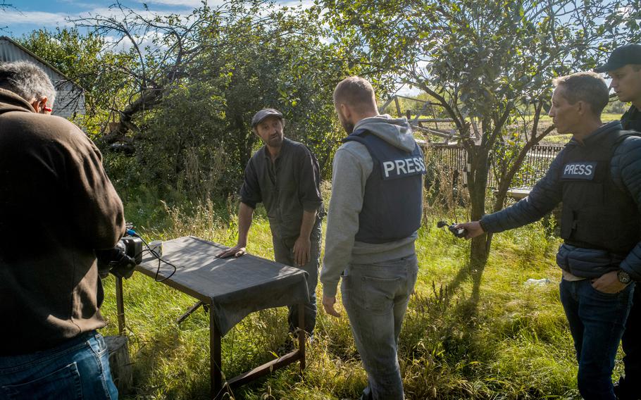 Andrei Dmitriev, 48, shows journalists where and how he said he was tortured in Pisky Radkivsky, Ukraine. 