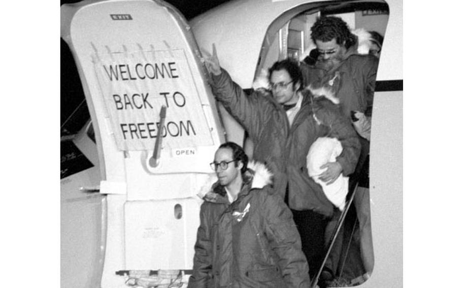 Freed hostages acknowledge the cheers of the crowd as they arrive at Rhein-Main.