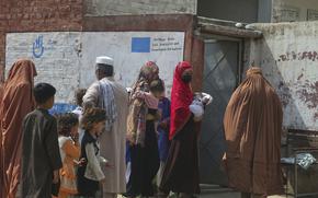 FILE - Afghan refugee women enter a health center at Kababayan Refugee Camp in Peshawar, Pakistan, on April 8, 2025. (AP Photo/Muhammad Sajjad, File)