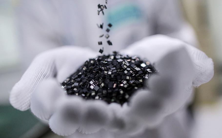 Semiconductor chips are arranged for a photograph on the production line at the Hana Microelectronics plant at the Hi-Tech Industrial Estate in Bang Pa-In, Ayutthaya province, Thailand, on Tuesday, April 22, 2014.