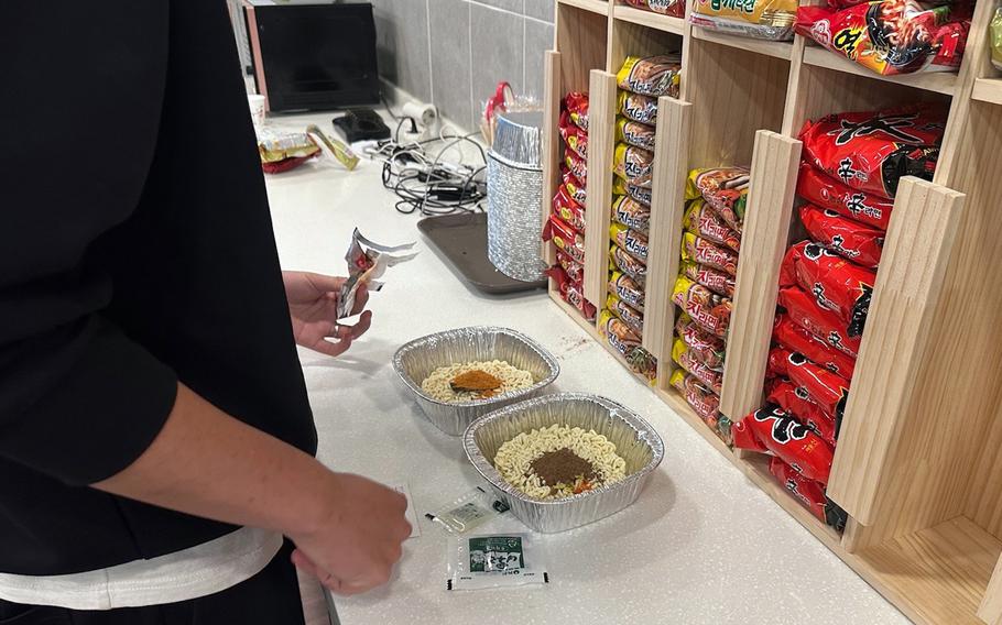 A guest prepares free instant ramen at White Castle, a room cafe in Suwon city, north of Osan Air Base, South Korea.