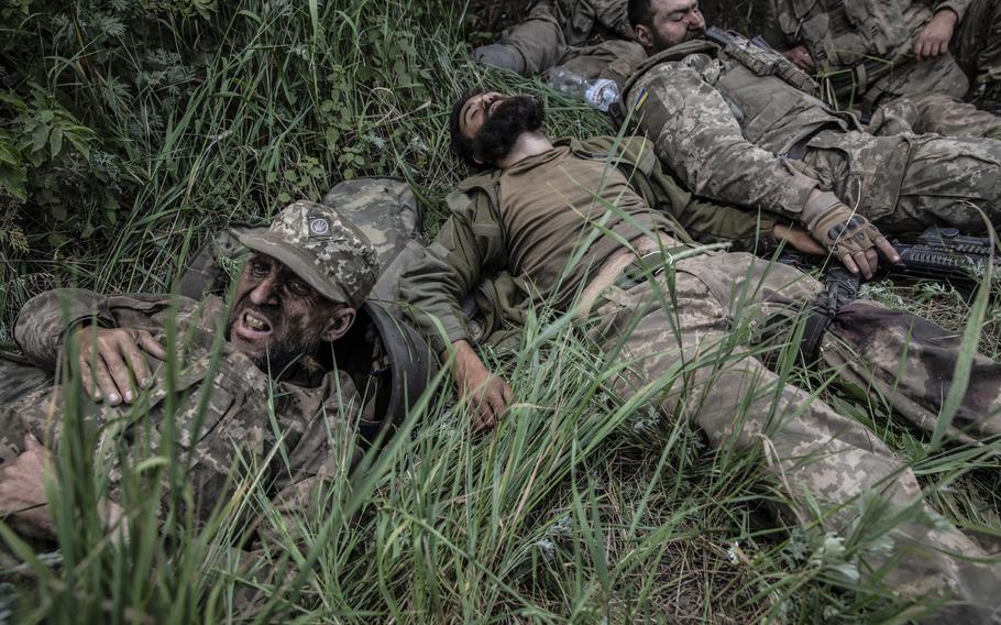 Wounded Ukrainian soldiers outside the embattled city of Lysychansk on June 26, 2022. A Russian strike hit them as they moved into the farm village of Verkhniokamianske. 