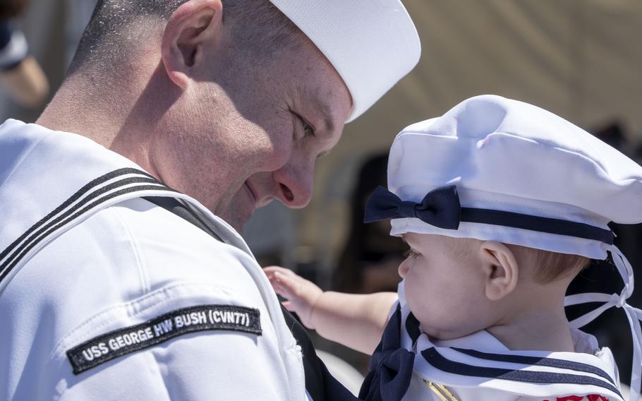 Electronics Technician 1st Class Karl Kraft, assigned to the USS George H.W. Bush, meets his daughter for the first time after the ship’s return to Naval Station Norfolk, Sunday, April 23, 2023. 