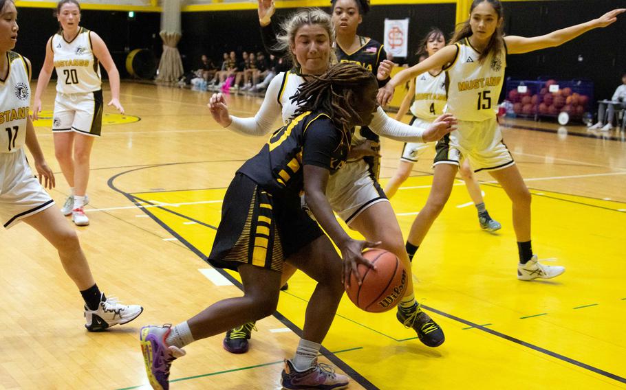Kadena's Jayla Johnson drives to the basket against American School In Japan. The Panthers rallied to win 30-24.