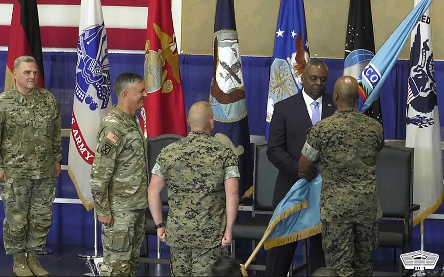 Gen. Mark Milley, chairman of the joint chiefs of staff, outgoing AFRICOM commander Gen. Stephen Townsend and Sgt. Maj. Richard Thresher, the command’s senior enlisted leader, from left, watch as  Defense Secretary Lloyd Austin hands the U.S. Africa Command guidon to Gen. Michael Langley during a change of command ceremony in Stuttgart, Germany, Aug. 9, 2022.