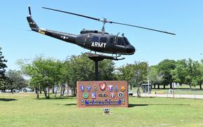 A helicopter is displayed above a gate sign for Fort Novosel.