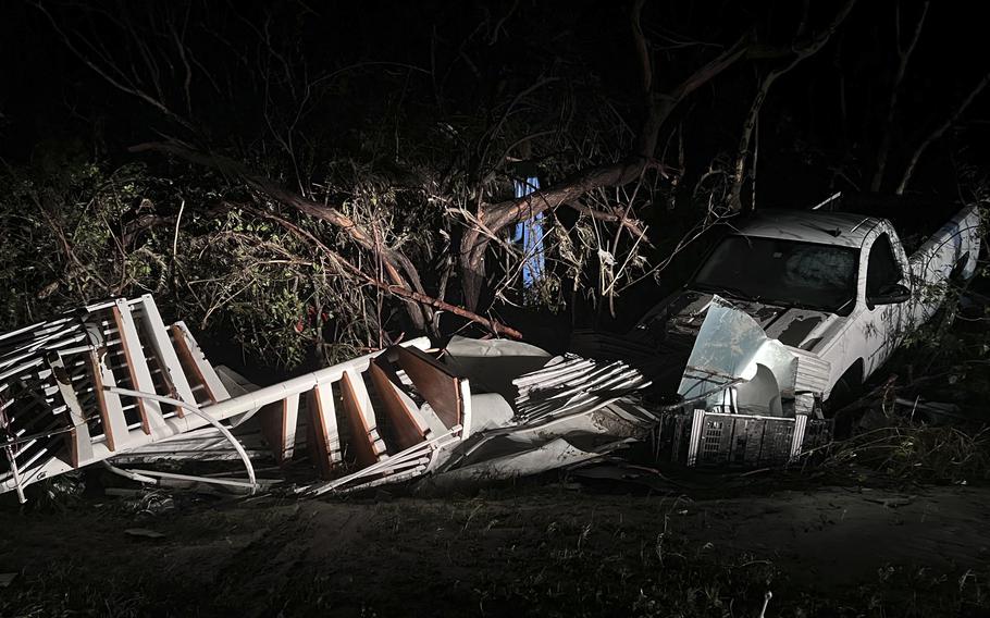 Just before the Sanibel Causeway, a spiral staircase was deposited in the brush next to a white pickup as Hurricane Ian passed the area Thursday, Sept.  29, 2022 in Sanibel, Fla.  