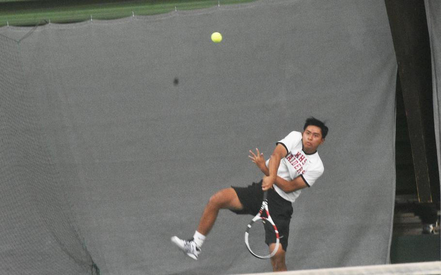 Kaiserslautern’s Micah San Pedro uses a powerful serve during a doubles semifinal in the DODEA-Europe tennis championships on Friday, Oct. 22, 2021.