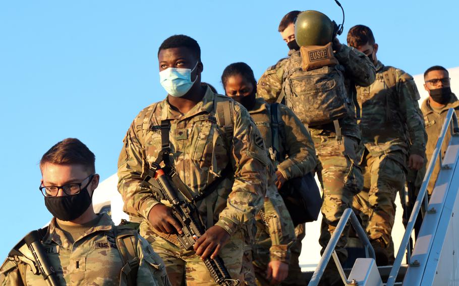 Soldiers from the 1st Armored Brigade Combat Team, 3rd Infantry Division disembark at the Nuremberg, Germany, airport Feb. 28, 2022, after arriving from the U.S. There are now 100,000 U.S. service members in Europe, the largest number since 2005.