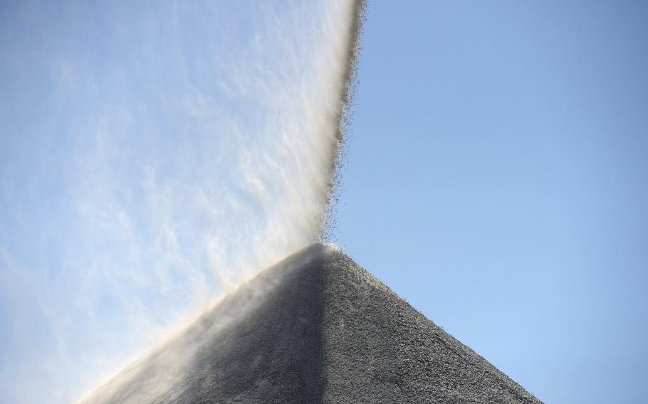 Lithium ore falls onto a stockpile at the Pilbara Minerals Pilgangoora project in Port Hedland, in Western Australia, on July 29, 2022.