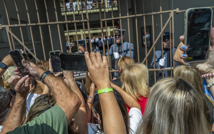 Parents and other relatives try to get one last glimpse — and photograph or video clip — of their children as the gates to student barracks are shut and Hell Week begins.