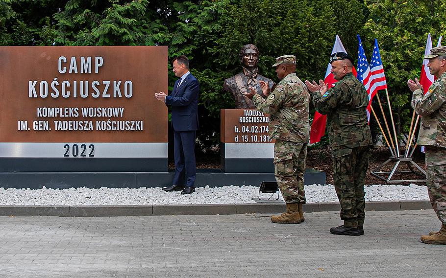 Polish Defense Minister Mariusz Blaszczak unveils the new name of the former Forward Operating Site Poznan, during a renaming ceremony at Poznan, Poland, in July 2022. Camp Kosciuszko is home to the new U.S. Army Garrison Poland and V Corps' forward headquarters. 