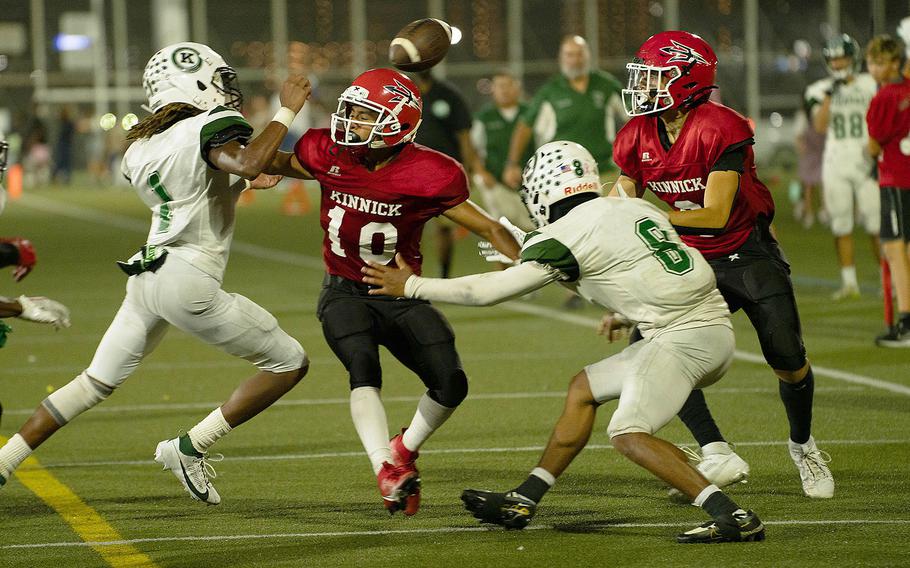 Kubasaki's Carlos Cadet and Trajon Weaver and Nile C. Kinnick's Michael Torres and Kellen Broach reach for a fumbled football.