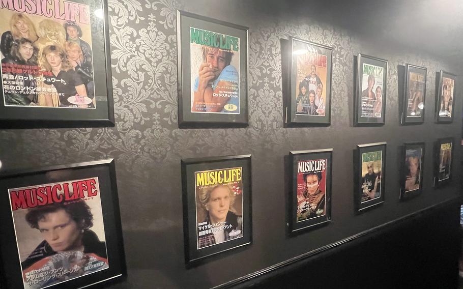 Magazine covers featuring rock musicians line a hallway at Bauhaus, a rock bar in Tokyo’s Roppongi district, July 24, 2022.