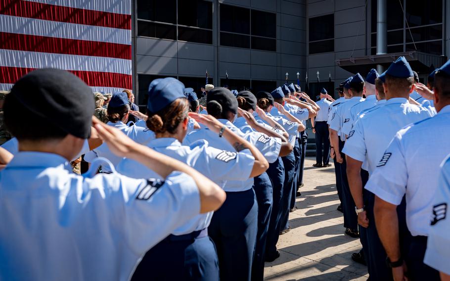 Troops salute standing in formation.