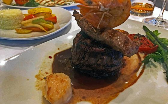 The surf ’n’ turf at the Parthenon restaurant in Frankfurt was a tower of beef and lamb fillets, topped by a shrimp with two scallops on the side.