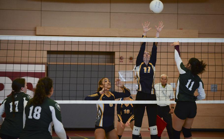 Ansbach Cougar Trinity Batin leaps into the air, attempting to block a shot delivered by AFNORTH Lion Richele Reyes during the DODEA Division III European volleyball semifinals on Oct. 27, 2023, in Kaiserslautern, Germany.