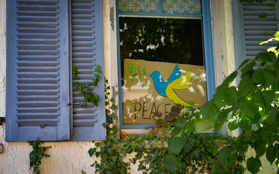 A sign calling for peace in Ukraine is seen in the window of a residential building in Baumholder, Germany, July 12, 2022. Through the decades, Baumholder residents have seen base activities ramp up and slow along with global developments.