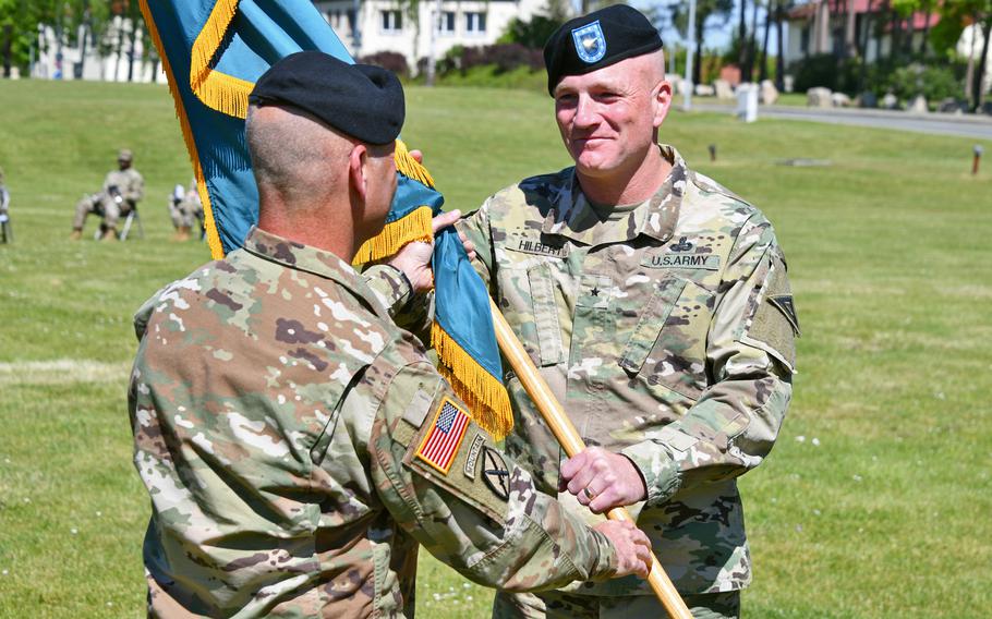 Brig. Gen. Joseph Hilbert, the incoming commander of the 7th Army Training Command, receives the 7th ATC guidon from Gen. Christopher Cavoli, U.S. Army Europe and Africa commander, during a ceremony on the parade field at Tower Barracks, Germany, June 2, 2021. 

Gertrud Zach/U.S. Army