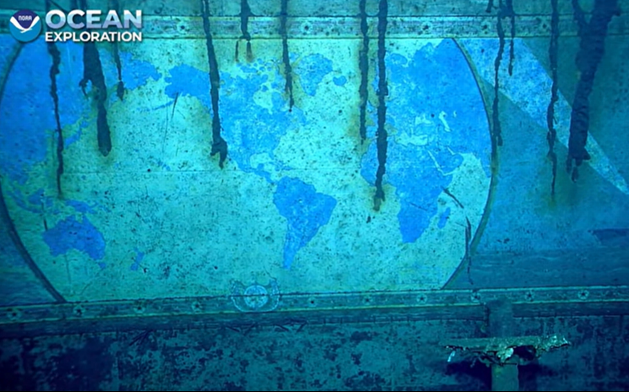 This video screengrab shows part of a mural on the sunken USS Yorktown that depicts the world as well as a painting of the ship in the bottom of the right-hand corner.