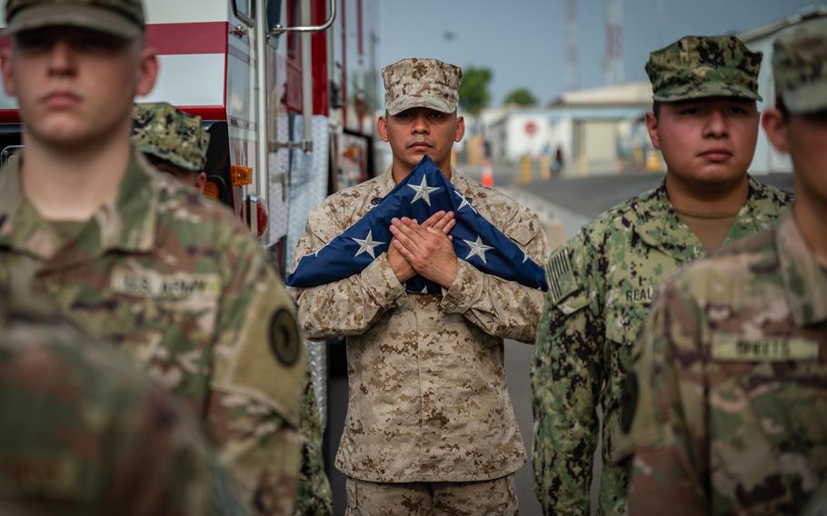 U.S. Marine Staff Sgt. Roberto Bravo, with Marine Air Refuel Transport Squadron 234, holds an American flag during a Patriot’s Day ceremony at Camp Lemonnier, Djibouti, Sept. 11, 2021, commemorating the 20th anniversary of 9/11.