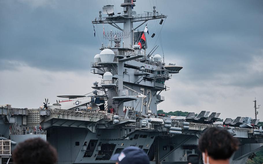 The aircraft carrier USS Abraham Lincoln arrives for a port call at Yokosuka Naval Base, Japan, Saturday, May 21, 2022.