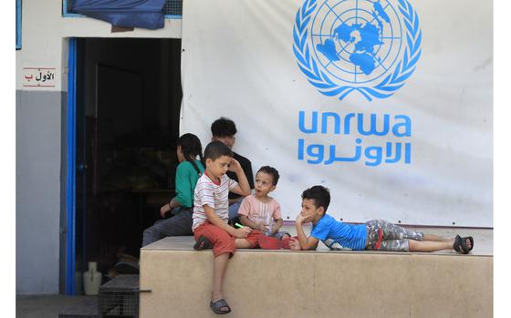 FILE - Palestinian children who fled with their parents from their houses in the Palestinian refugee camp of Ein el-Hilweh, gather in the backyard of an UNRWA school, in Sidon, Lebanon, Sept. 12, 2023.  An independent review released Monday, April 22, 2024, of the neutrality of UNRWA, the U.N. agency helping Palestinian refugees, has found that Israel never expressed concern about anyone on the staff lists it has received annually since 2011. The review was carried out after Israel alleged that a dozen employees of the agency had participated in Hamas’ Oct. 7 attacks.  (AP Photo/Mohammed Zaatari, File)