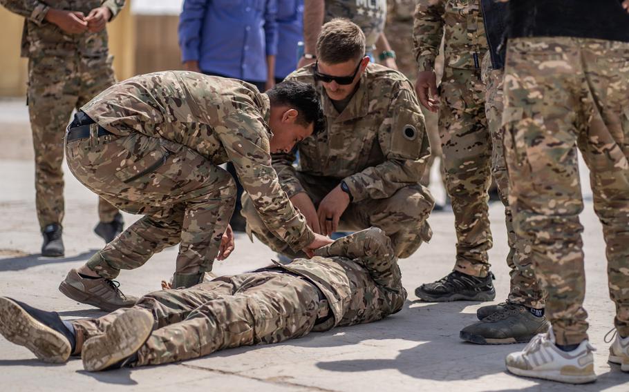 A Syrian Internal Security Forces student checks for a pulse on a simulated casualty during instruction in al-Hasakah province, Syria, on May 6, 2023.