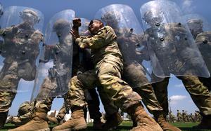 Sgt. 1st Class Andres Agag, a mortar team leader with Troop A, 1st Squadron, 18th Cavalry Regiment, California Army National Guard, pushes against the shields of other unit members while playing the role of an aggressive demonstrator during training at Joint Forces Training Base, California, on riot and crowd control techniques, June 22, 2025. U.S. Northern Command is supporting federal agencies by providing military forces to protect federal functions, personnel, and property in the greater Los Angeles area. On June 7, the Secretary of Defense directed USNORTHCOM to establish Task Force 51 to oversee Title 10 forces supporting this mission. (U.S. Army photo by Sgt. 1st Class Jon Soucy)