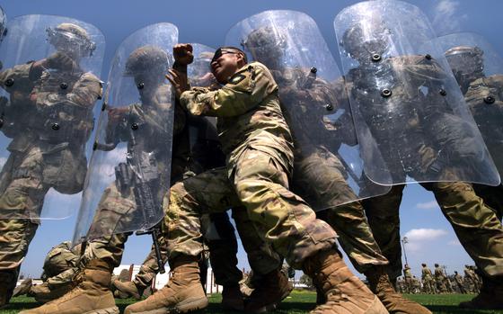 Sgt. 1st Class Andres Agag, a mortar team leader with Troop A, 1st Squadron, 18th Cavalry Regiment, California Army National Guard, pushes against the shields of other unit members while playing the role of an aggressive demonstrator during training at Joint Forces Training Base, California, on riot and crowd control techniques, June 22, 2025. U.S. Northern Command is supporting federal agencies by providing military forces to protect federal functions, personnel, and property in the greater Los Angeles area. On June 7, the Secretary of Defense directed USNORTHCOM to establish Task Force 51 to oversee Title 10 forces supporting this mission. (U.S. Army photo by Sgt. 1st Class Jon Soucy)