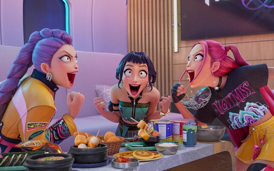 From left, Rumi, Zoey, and Mira surrounded by food in a scene from “KPop Demon Hunters.” 