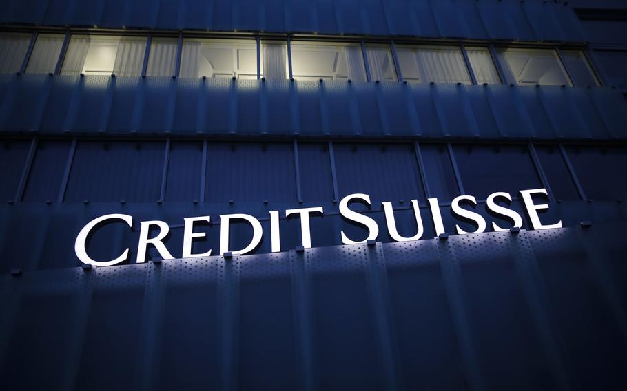 An illuminated Credit Suisse sign above the entrance to a Credit Suisse Group office building at night in Muri, Bern, Switzerland, on Feb. 15, 2021.