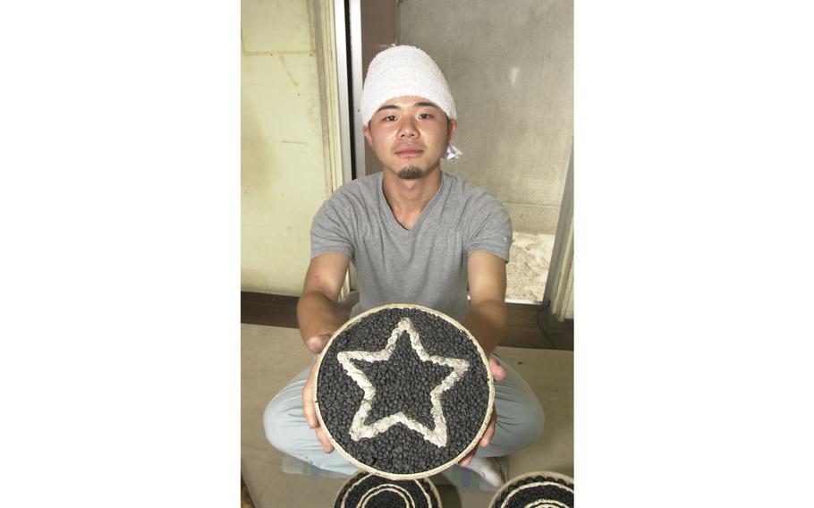 Toshikazu Kosuge shows the inside of a firework that blows up into a star pattern.