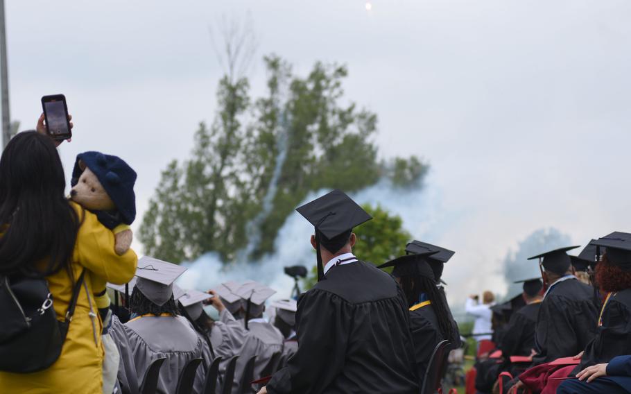 Graduates with the University of Maryland Global Campus Europe class of 2022 watch a fireworks display at the close of commencement exercises on Saturday, April 30, 2022, in Obersuelzen, Germany.